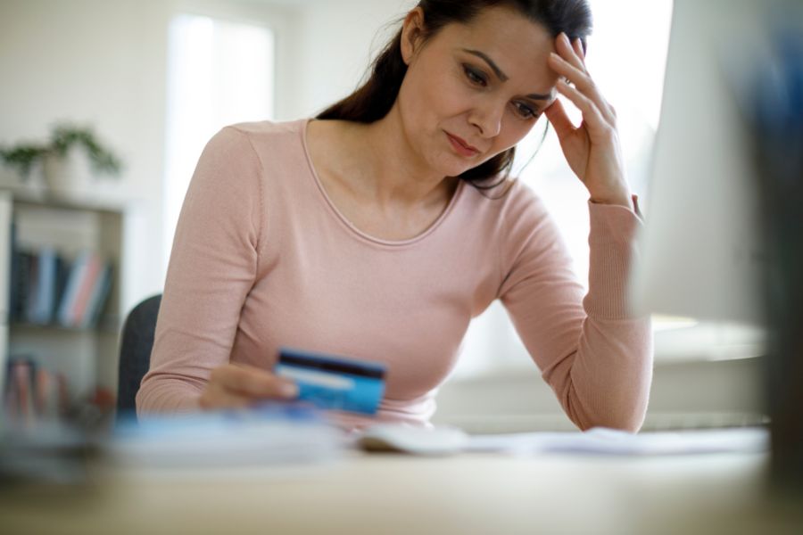 mujer con tarjeta de crédito haciendo frente a sus deudas